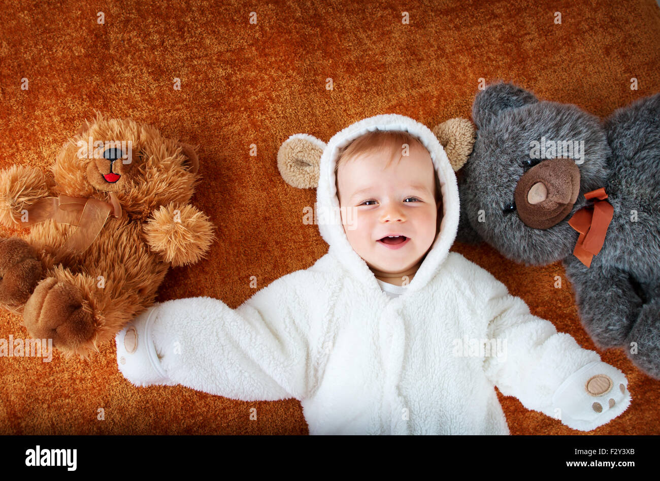 Little baby in bear costume with plush toys Stock Photo Alamy