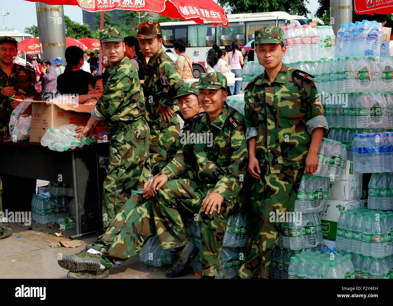 Pengzhou, China:  Chinese soldiers standing with donated bottled water for the victims of the 5-12-08 Sichuan earthquake Stock Photo