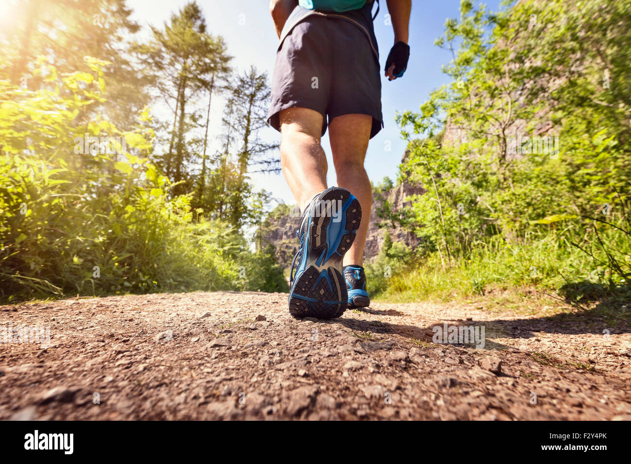 Man jogging or waking outdoors on a footpath or trail concept for healthy lifestyle, sport exercising, running and fitness Stock Photo