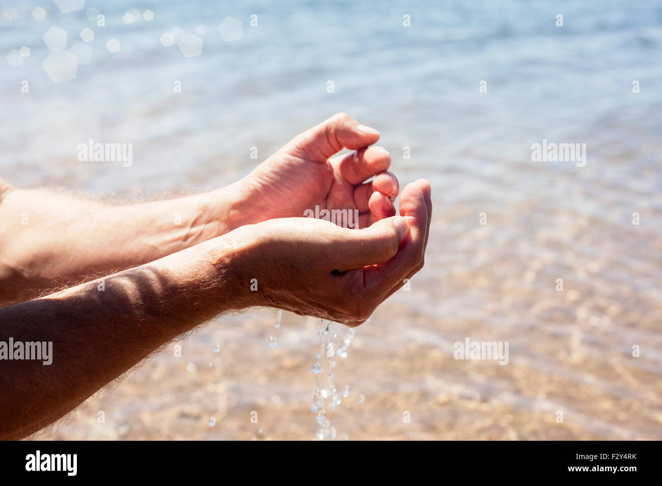 Clean life giving pure and fresh water in cupped hands Stock Photo