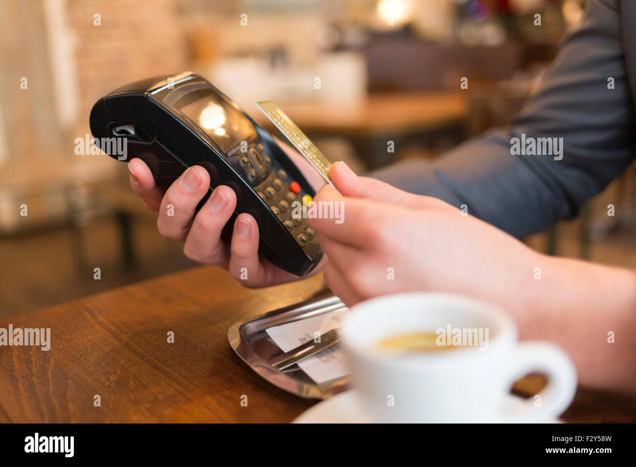 Man paying with NFC technology , credit card, in restaurant, bar, cafe Stock Photo