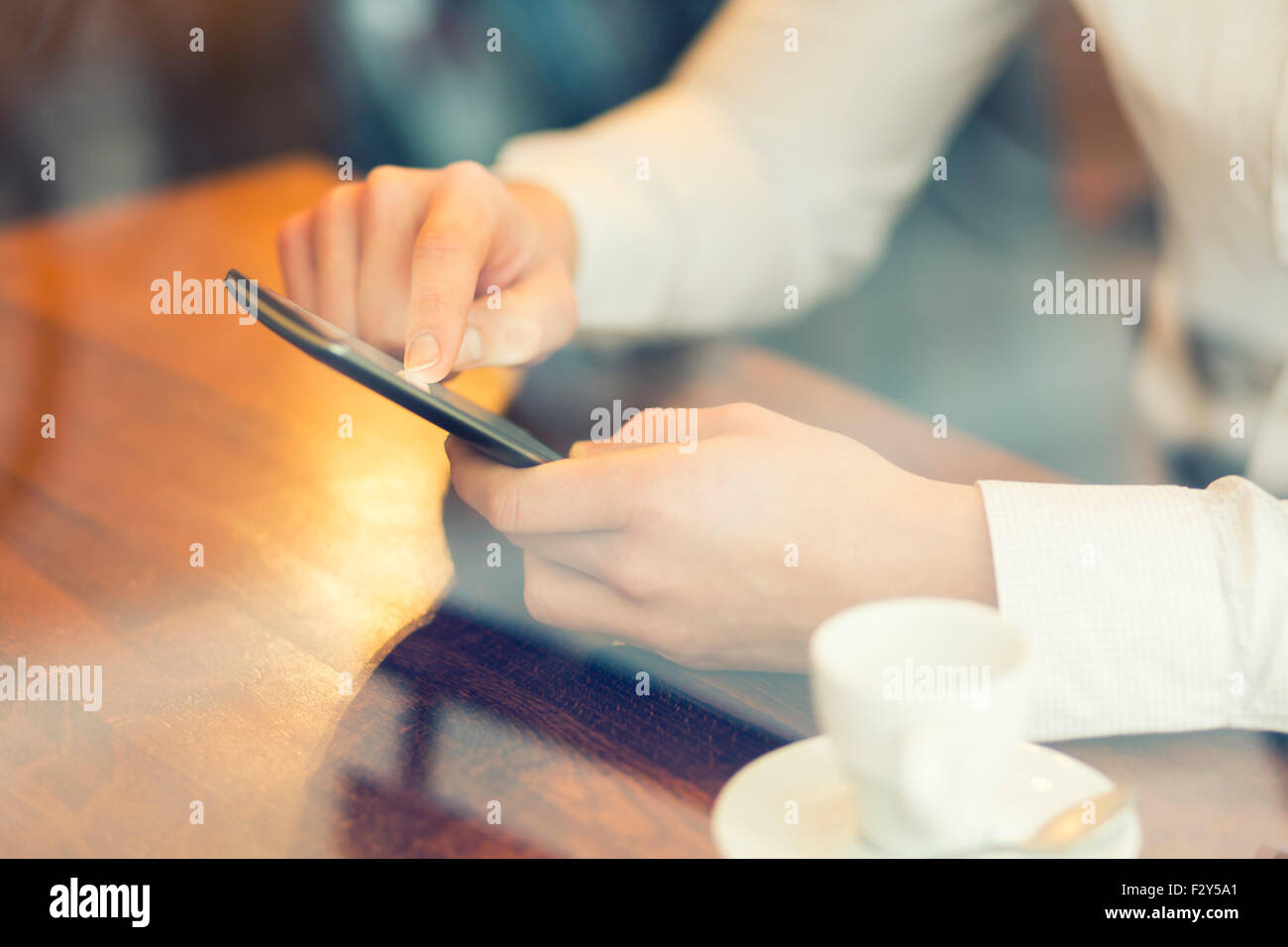 Man in a bar using mobile phone. Vintage filter Stock Photo