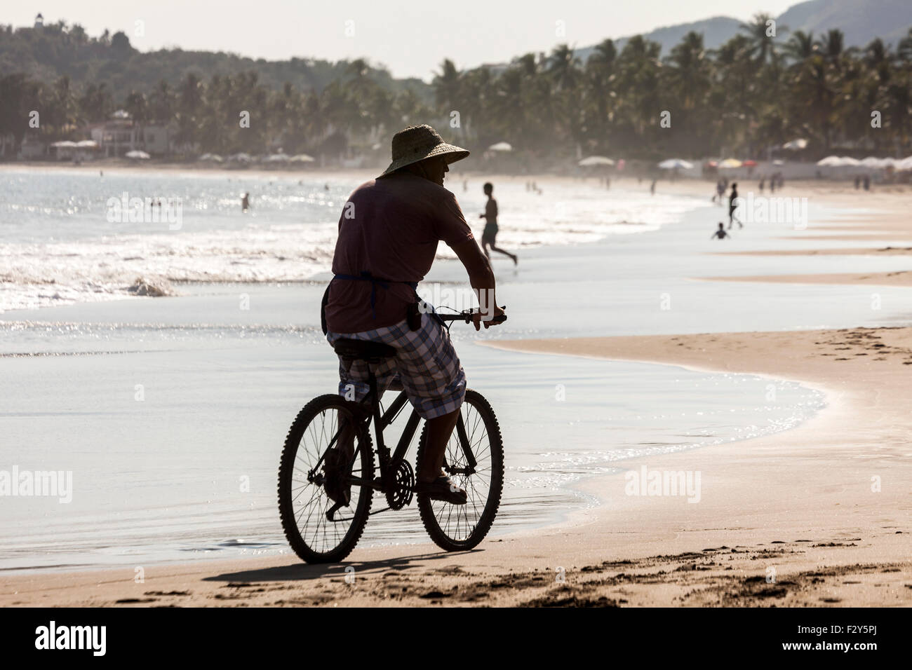 Salesman on a bicycle Manzanillo beach Pacific Ocean Colima Mexico North America Stock Photo