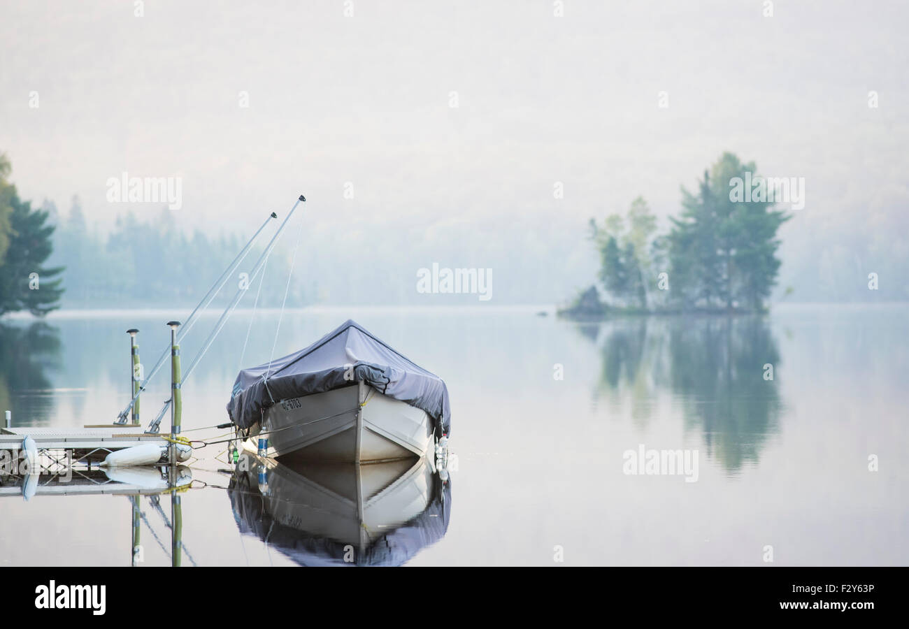 boat under wraps at dock on lake Stock Photo