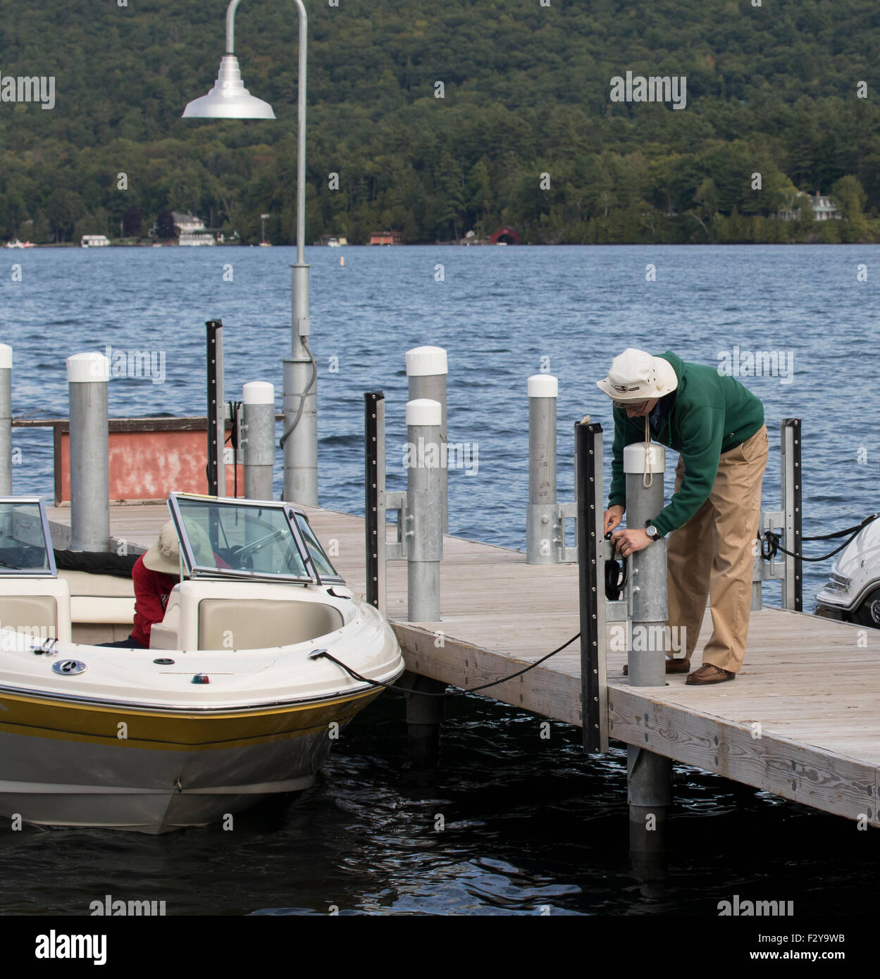 Tying up a pleasure boat at the dock at Lake New York USA US