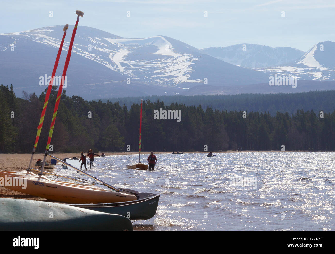 Water sports on Loch Morlich with view of Snow Covered Cairngorm in background Stock Photo