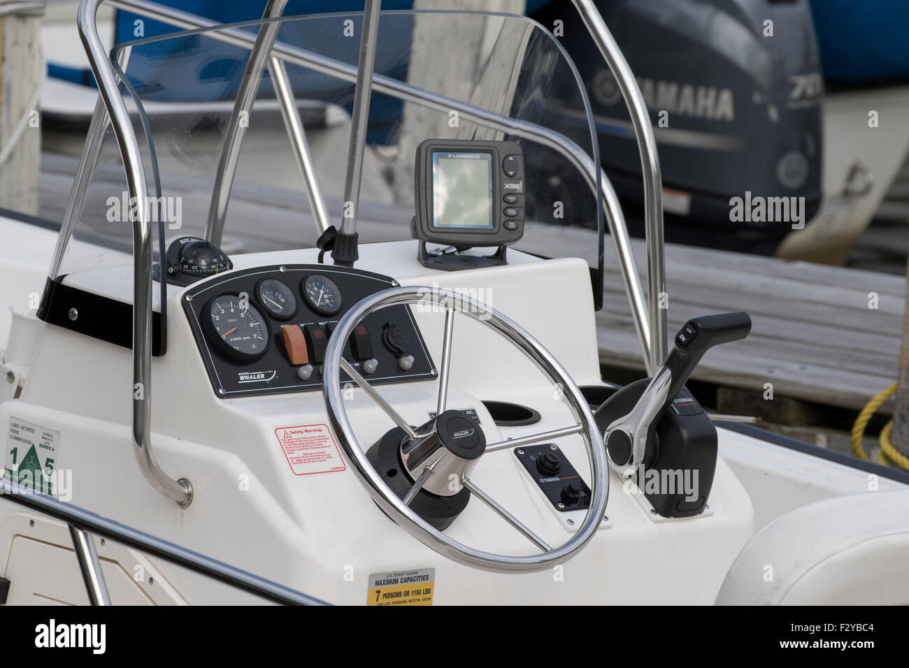 Boston whaler boat console steering wheel throttle fish finder. Stock Photo