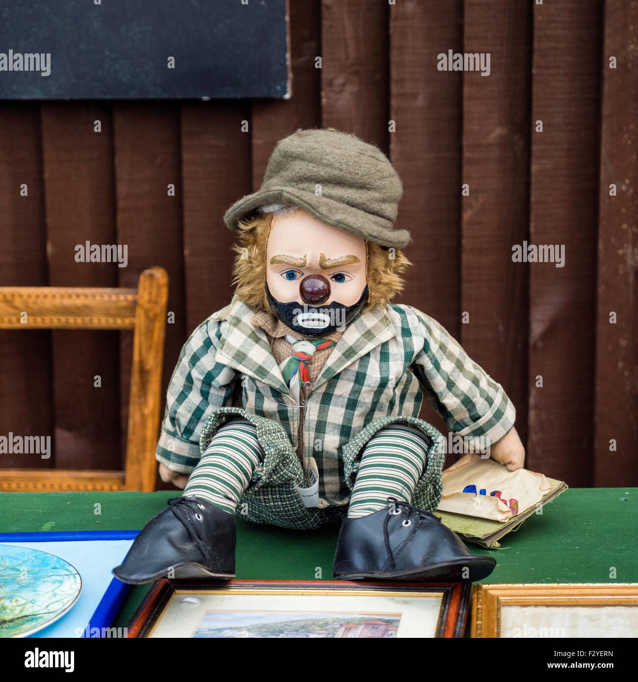 Flea Market, Greenwich, London. Collectibles, clown doll at market stall Stock Photo