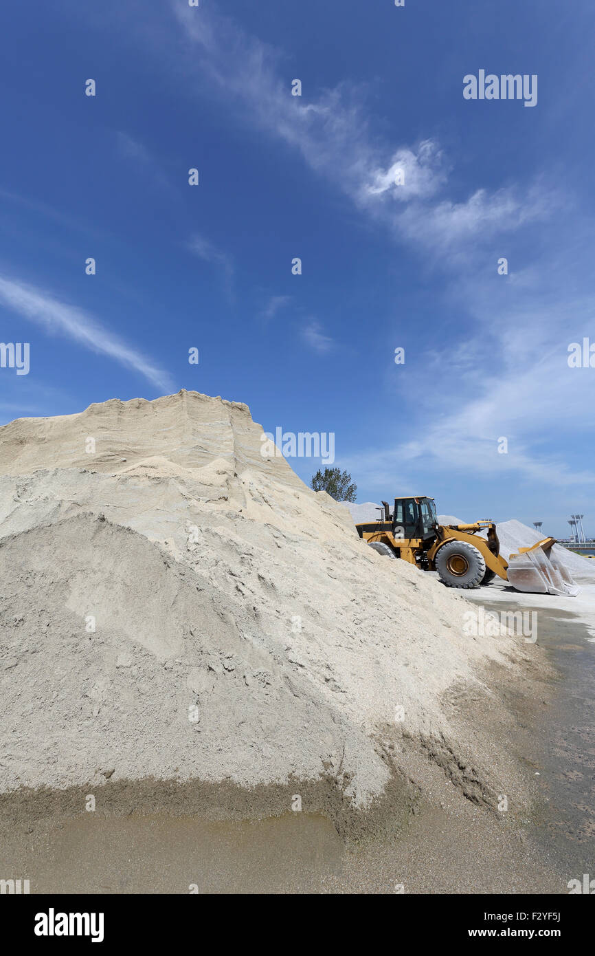 gravel sand mound against a blue sky Stock Photo