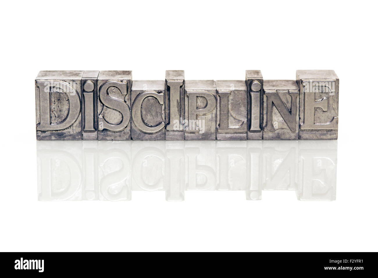 discipline word made from metallic letterpress type on reflective surface Stock Photo