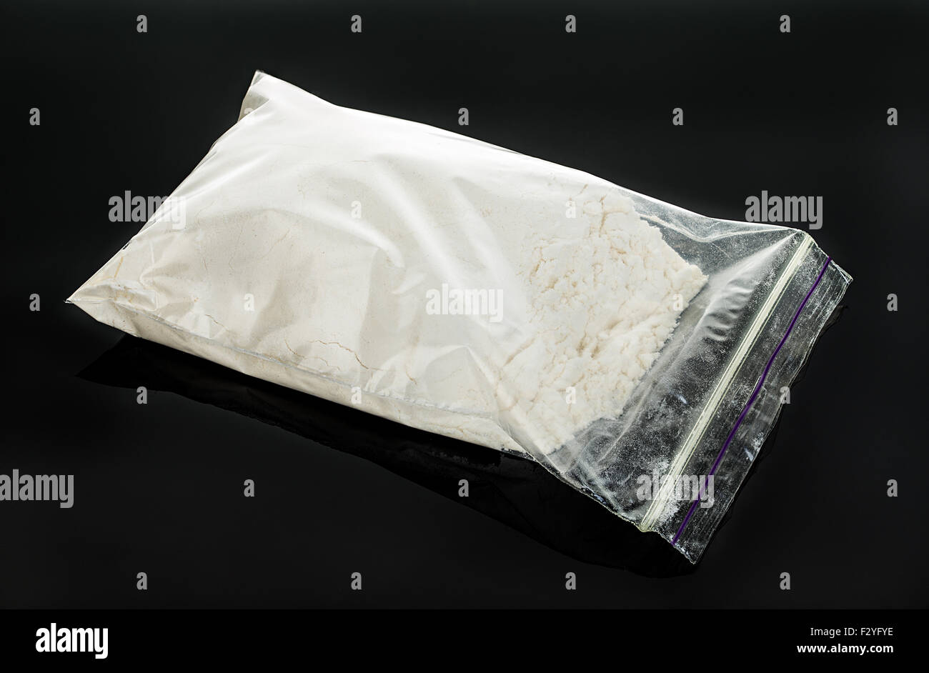 Drug powder close-up on a black background. Stock Photo