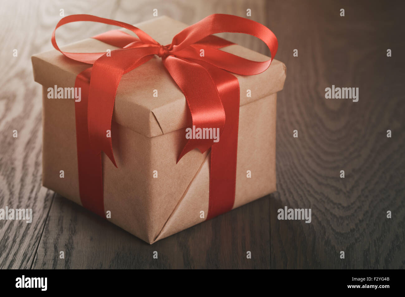 rustic gift box with red ribbon bow Stock Photo