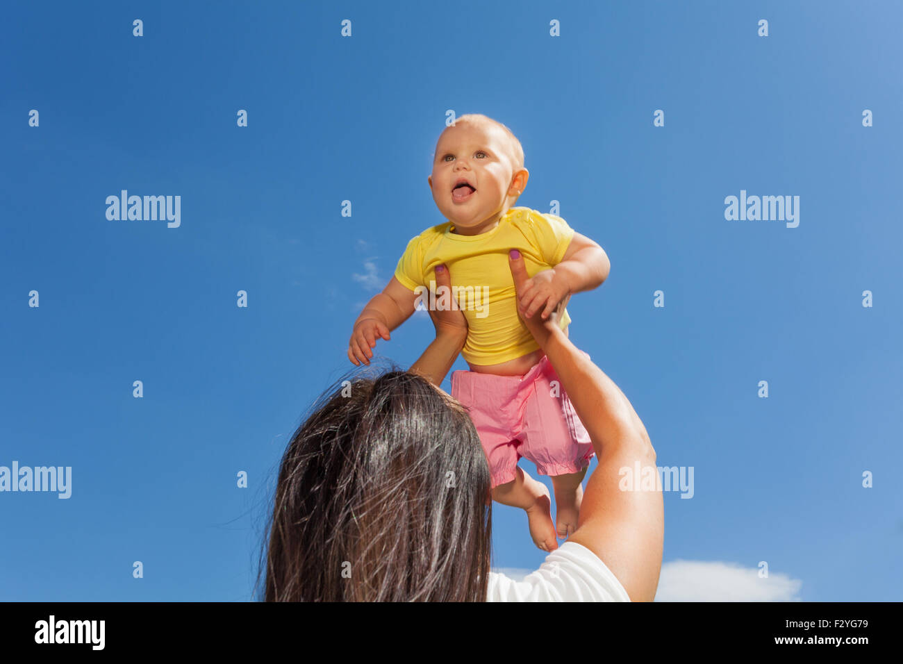 Mother holds her baby up with straight arms Stock Photo Alamy