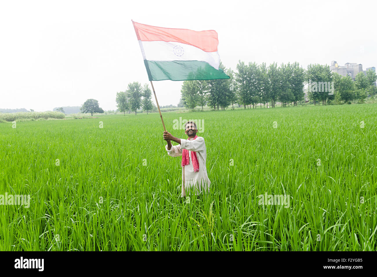 Indian farmer holding indian flag hi-res stock photography and images