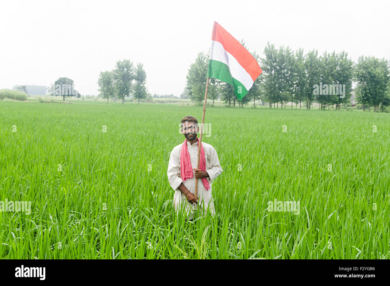 Indian farmer holding indian flag hi-res stock photography and images