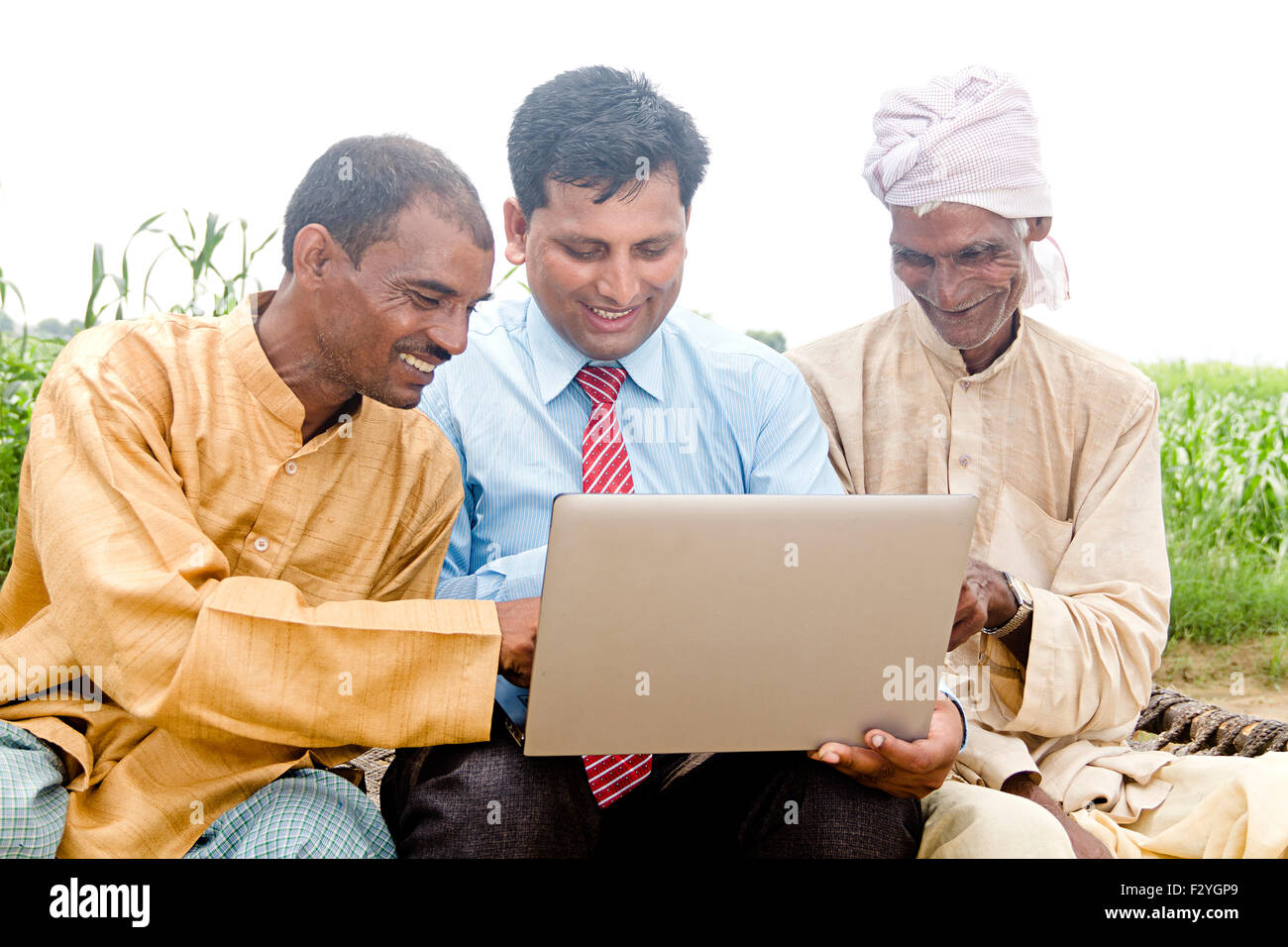 3 indian Business Man and rural farmer farm laptop working Stock Photo