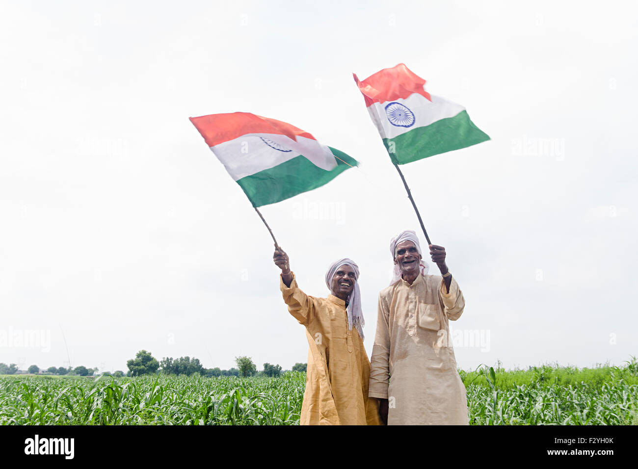 2 indian rural farmer friends farm Fluttering Flag Independence Day Stock Photo