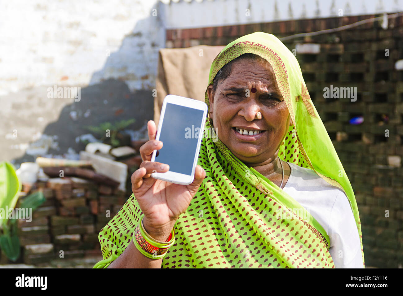 1 indian rural Senior woman Mobile Phone Quality showing Stock Photo