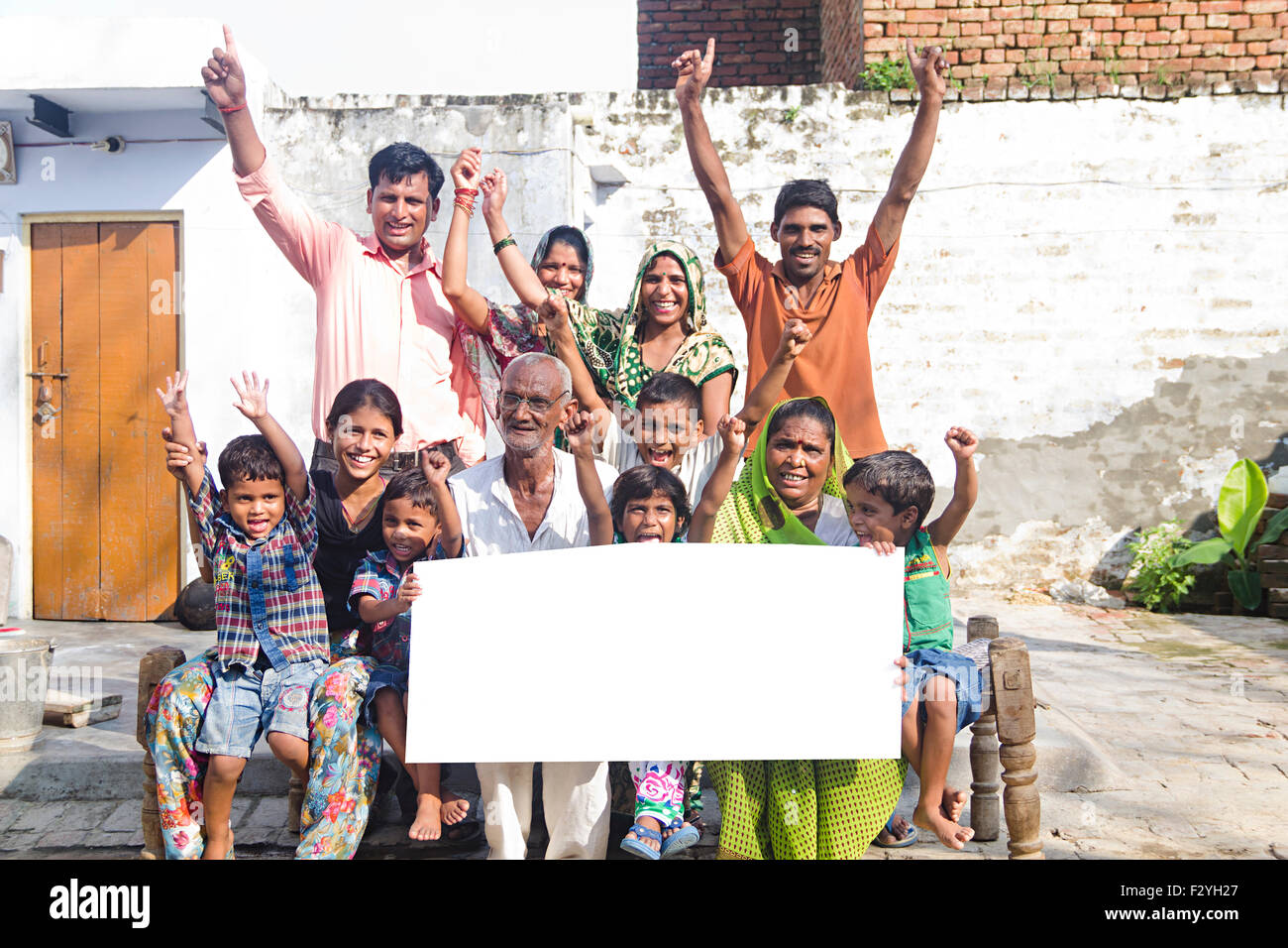 indian group crowds rural villager Joint Family home sitting Message Board showing Stock Photo