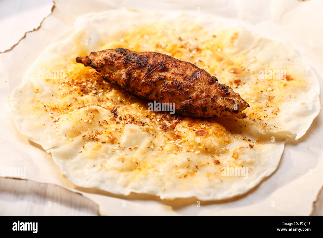 Shish kofte (kofta kebab) on naan spiced flatbread Stock Photo