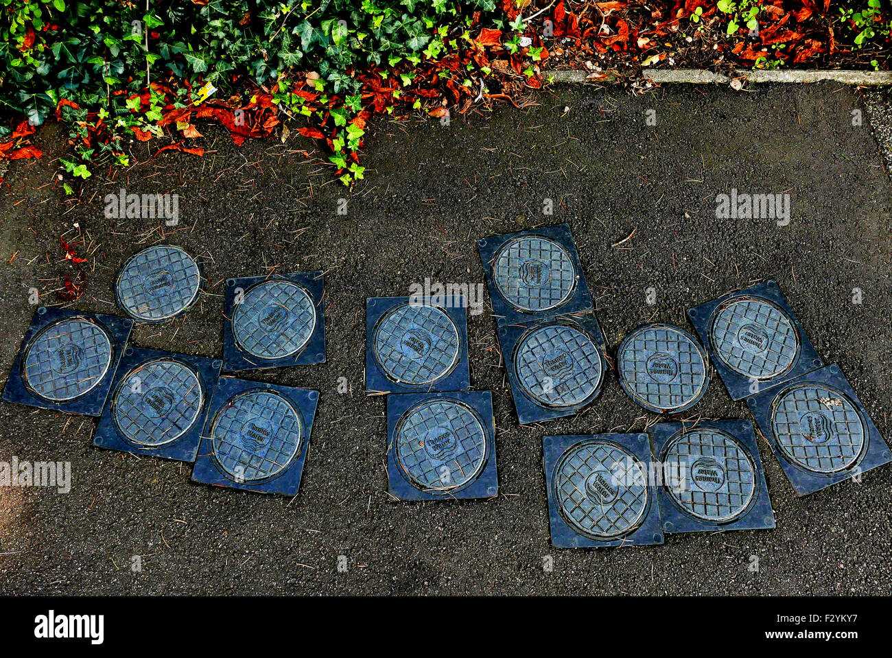 Water meter inspection covers set into a pavement Stock Photo Alamy