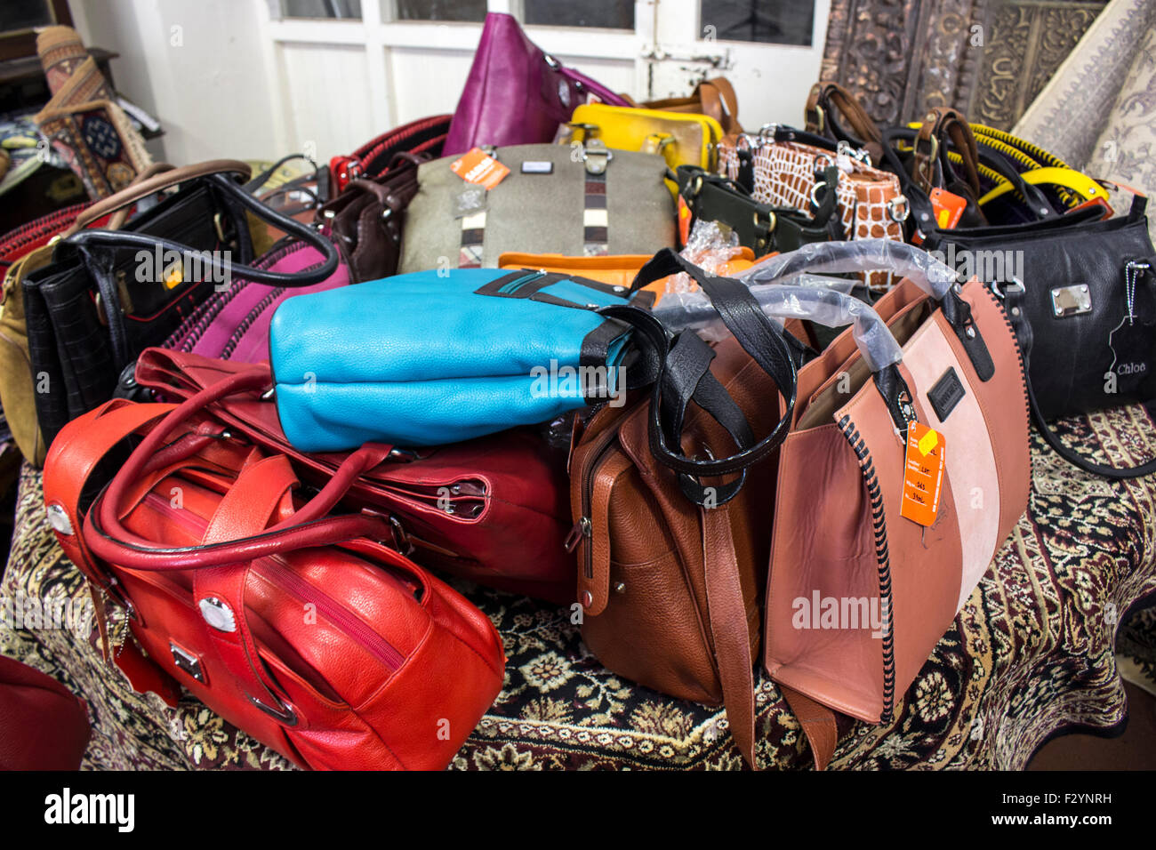 Fake leather handbags for sale in junk shop Stock Photo