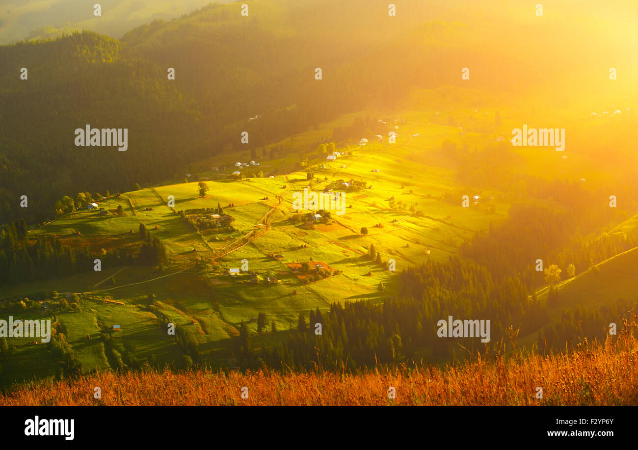Autumn hill with warm sunlight at sunrise.travel Stock Photo