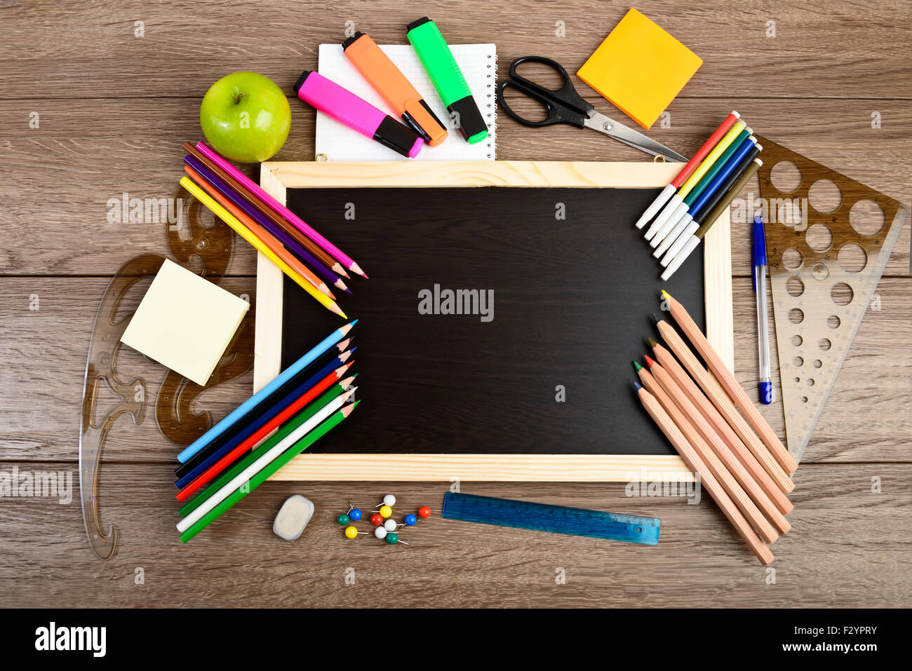 School supplies on blackboard background ready for your design Stock Photo