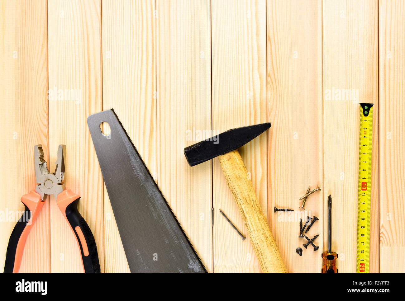 Assorted work tools on wooden background Stock Photo