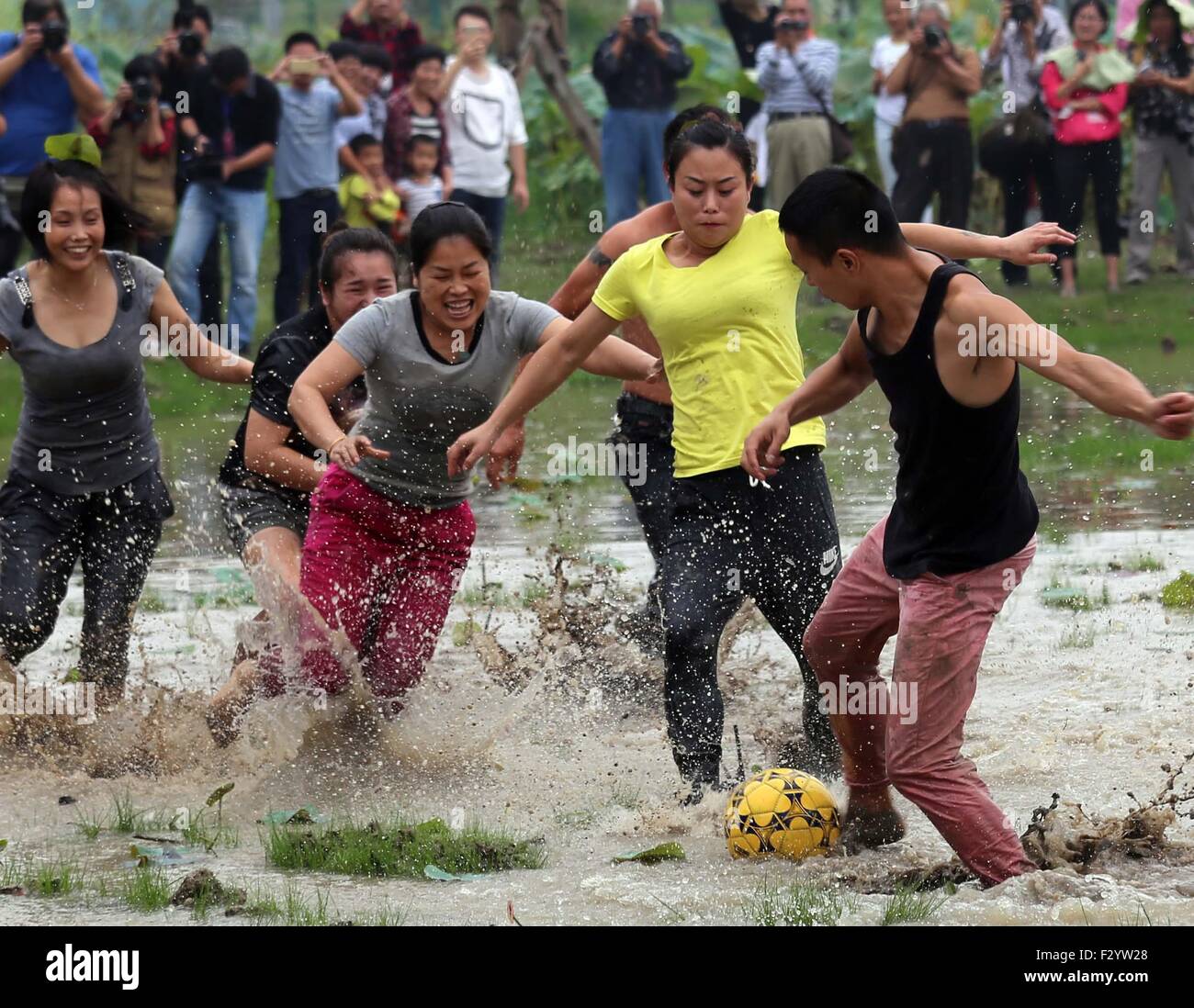 Wuyi, China's Zhejiang Province. 26th Sep, 2015. People play soccer in mud in Housangyuan Village of Lyutan Township of Wuyi County, east China's Zhejiang Province, Sept. 26, 2015. Local villagers held a mud soccer competition to celebrate the upcoming Mid-Autumn Festival. Credit:  Ge Yuejin/Xinhua/Alamy Live News Stock Photo