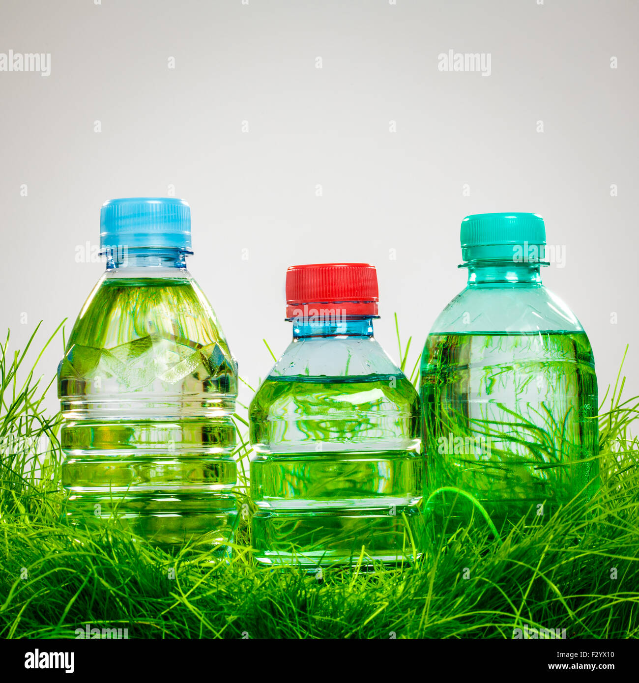 Bottle of water on the green grass Stock Photo - Alamy