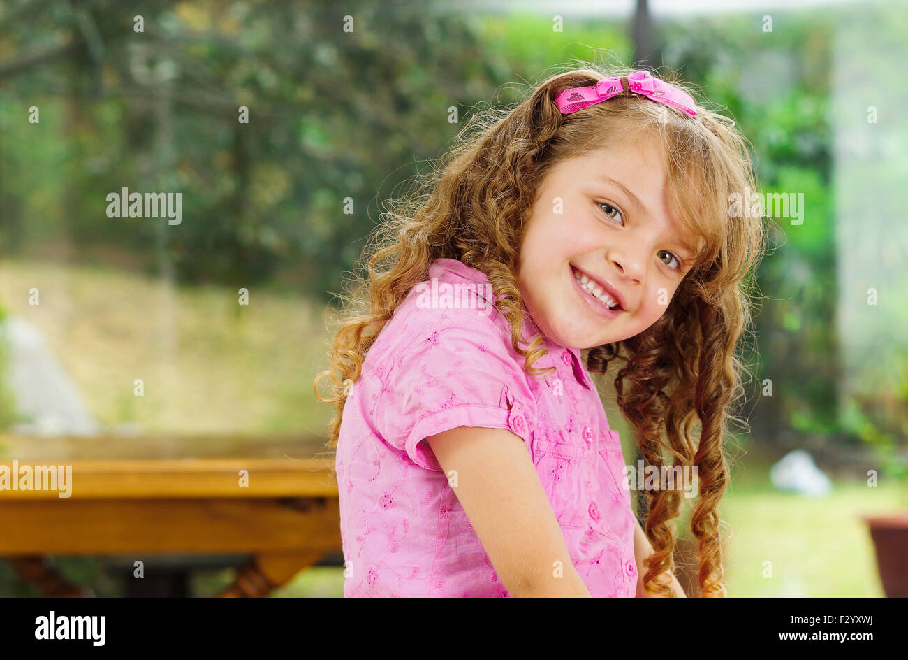 Beautiful Young Hispanic Girl With Pink Clothing Smiling Cute At