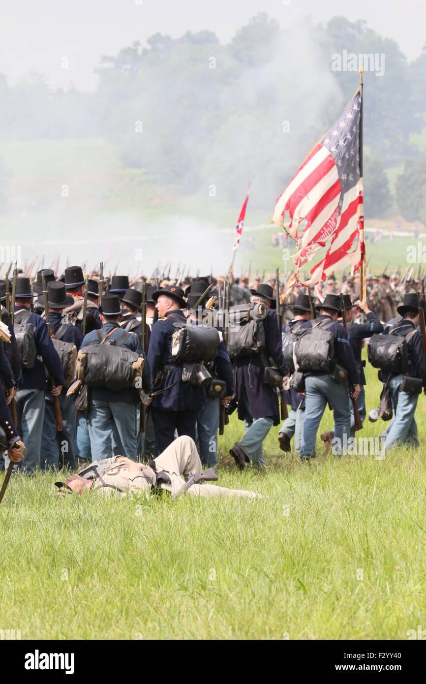 Union Civil War reenactors walk past a fallen Confederate solder at the 150th anniversary of the Battle of Gettysburg, June 28, Stock Photo
