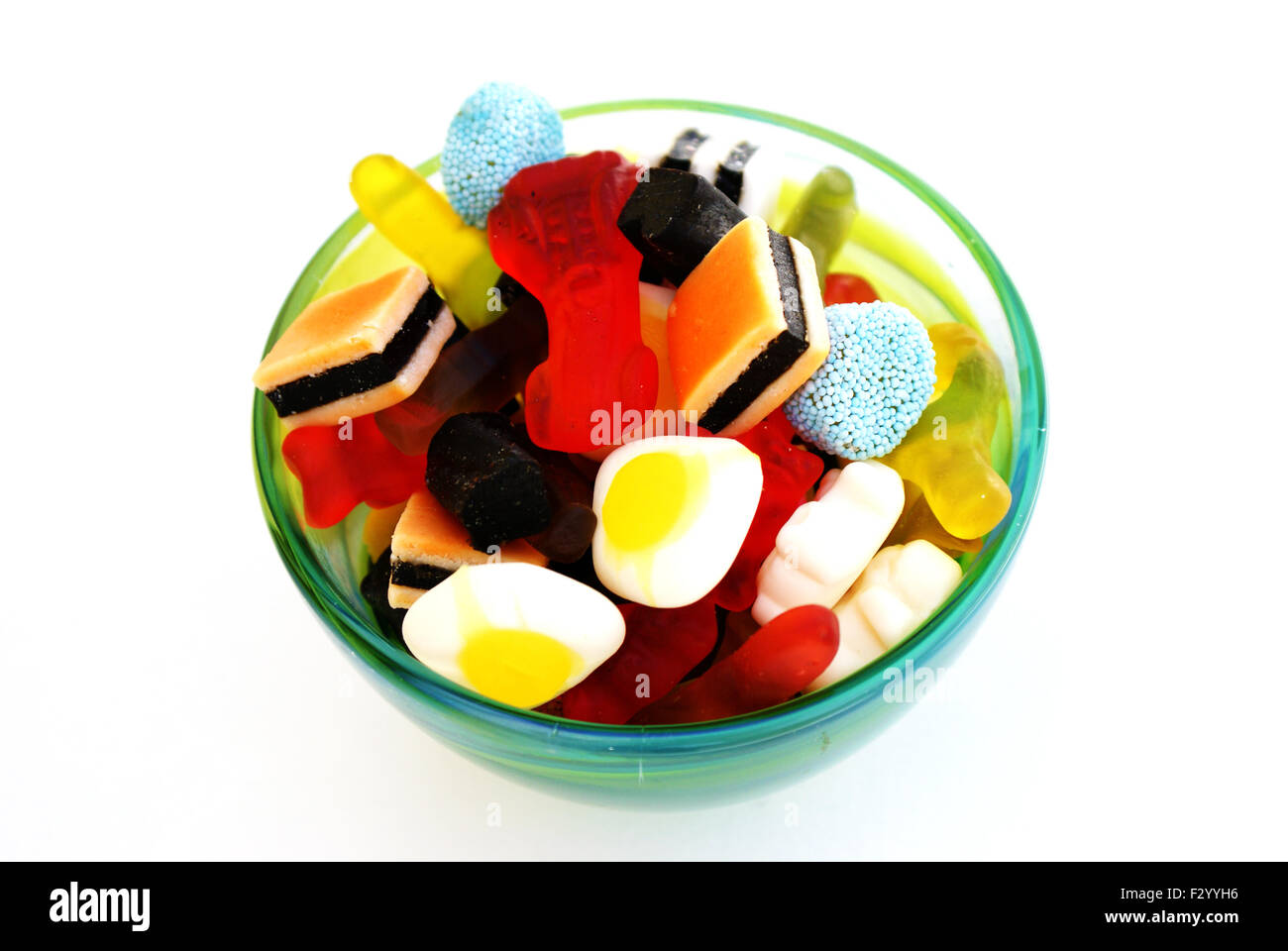 Delicious candy in green glass bowl Stock Photo