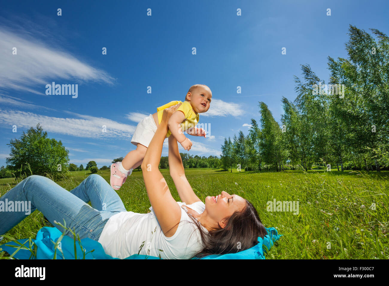 Mother lifting her baby up with straight arms Stock Photo Alamy