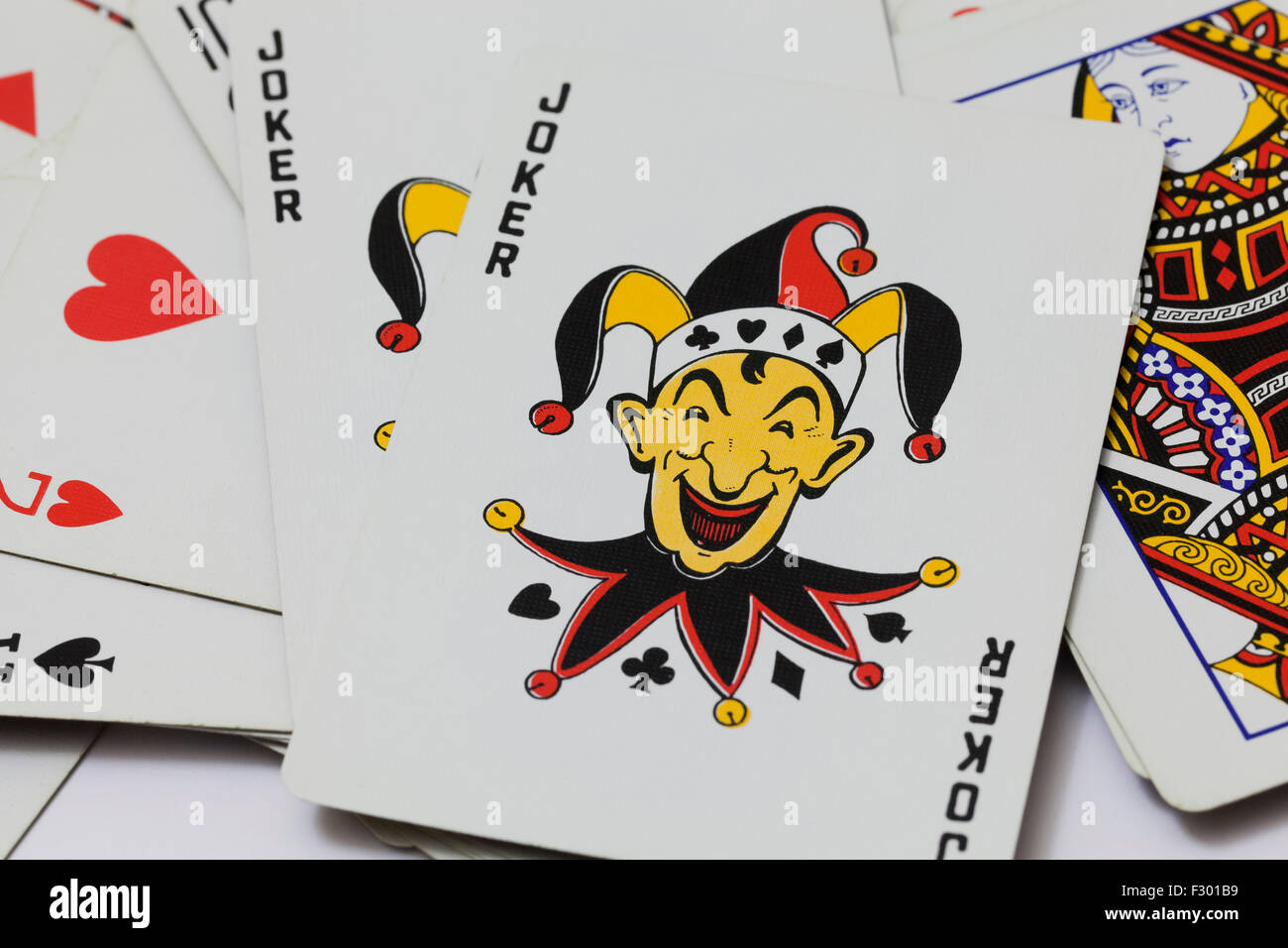 Joker on top of playing cards Stock Photo - Alamy