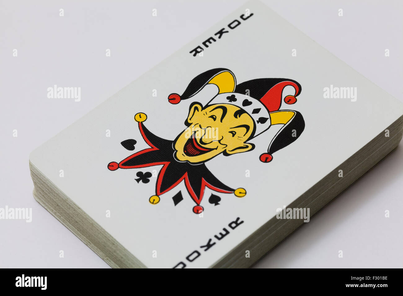 Joker on top of playing cards Stock Photo