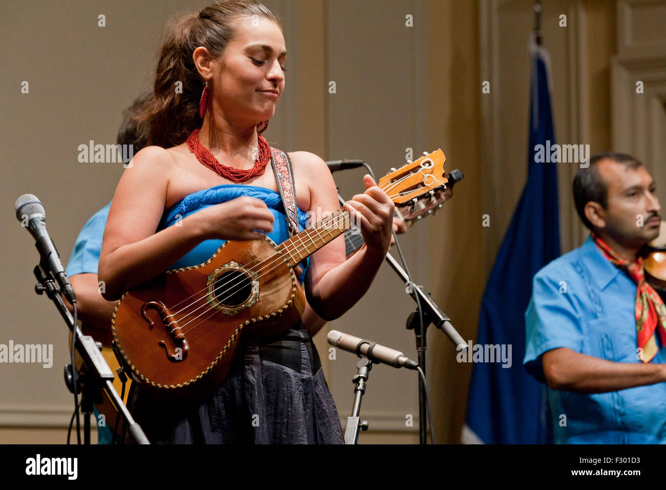 Mexican woman playing vihuela (timple Canario) on stage - USA Stock Photo