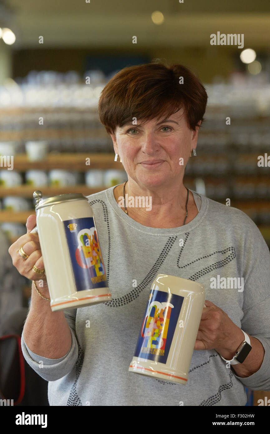 Hoehr-Grenzhausen, Germany. 15th Sep, 2015. Sabine Sahm, owner of the drinking vessel manufacturer Rastal, presents the official collector's beer mug for the Oktoberfest in Naples, Italy, in the production hall of the company in Hoehr-Grenzhausen, Germany, 15 September 2015. The beer mugs for the world's largest beer festival Oktoberfest in Munich are manufactured in this region. Photo: Thomas Frey/dpa/Alamy Live News Stock Photo