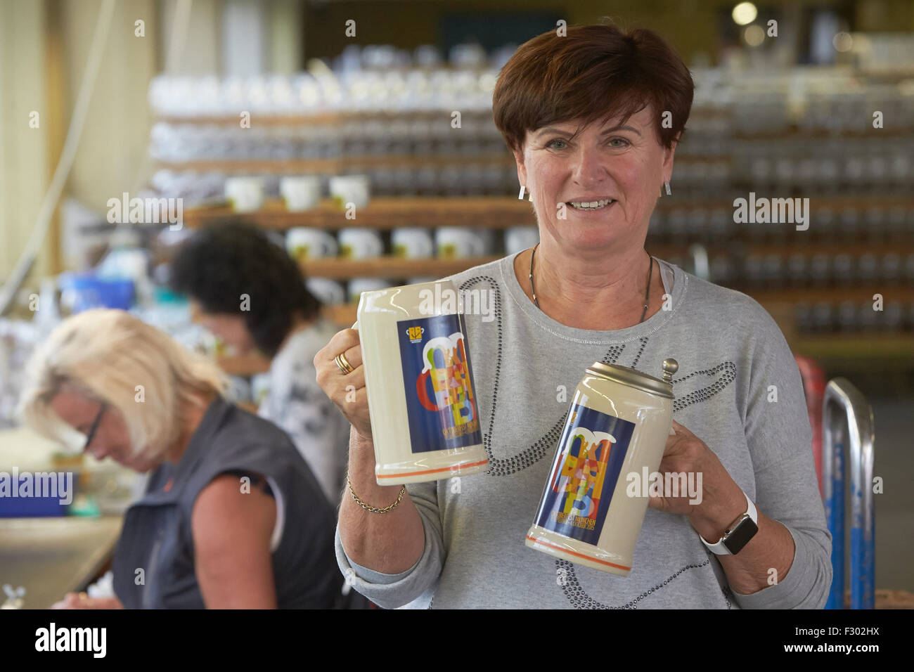 Hoehr-Grenzhausen, Germany. 15th Sep, 2015. Sabine Sahm, owner of the drinking vessel manufacturer Rastal, presents the official collector's beer mug for the Oktoberfest in Naples, Italy, in the production hall of the company in Hoehr-Grenzhausen, Germany, 15 September 2015. The beer mugs for the world's largest beer festival Oktoberfest in Munich are manufactured in this region. Photo: Thomas Frey/dpa/Alamy Live News Stock Photo