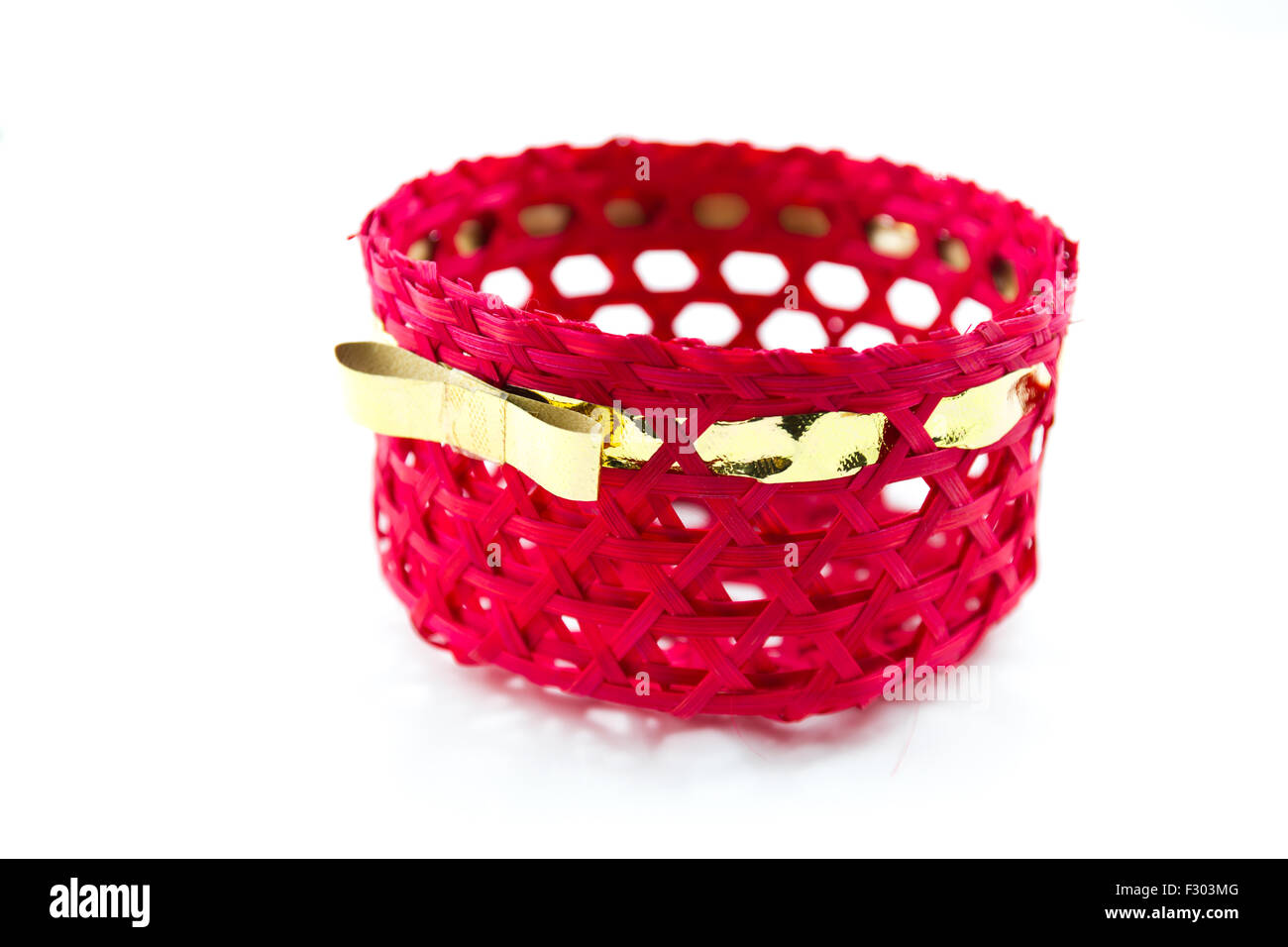 Red basket with golden ribbon in white background Stock Photo Alamy