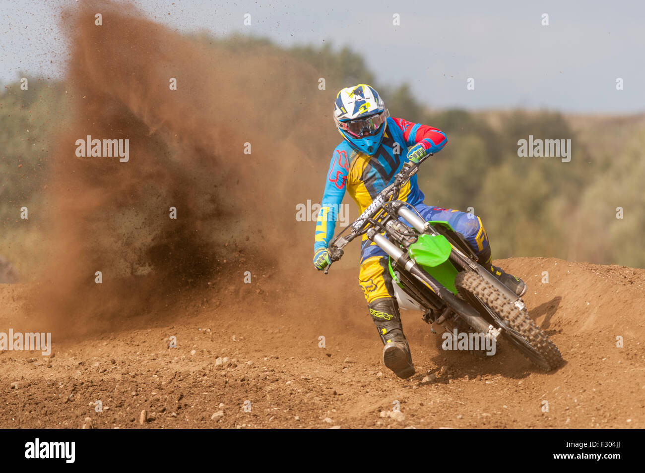 Motocross Rider riding fast out of a bend Stock Photo - Alamy