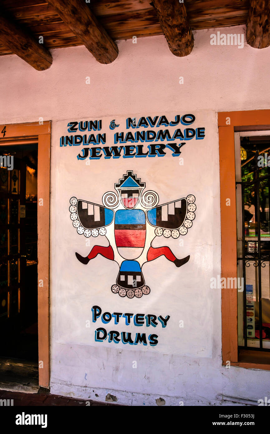 Hand-painted on the wall outside a store in Albuquerque NM, a Zuni bird and writing advertising Zuni and Navajo Indian handmade Stock Photo