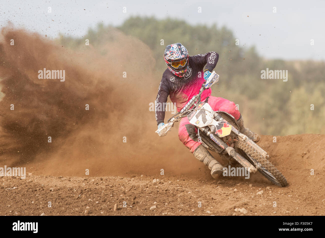Motocross Rider going fast around a bend and leaving a trail of dust