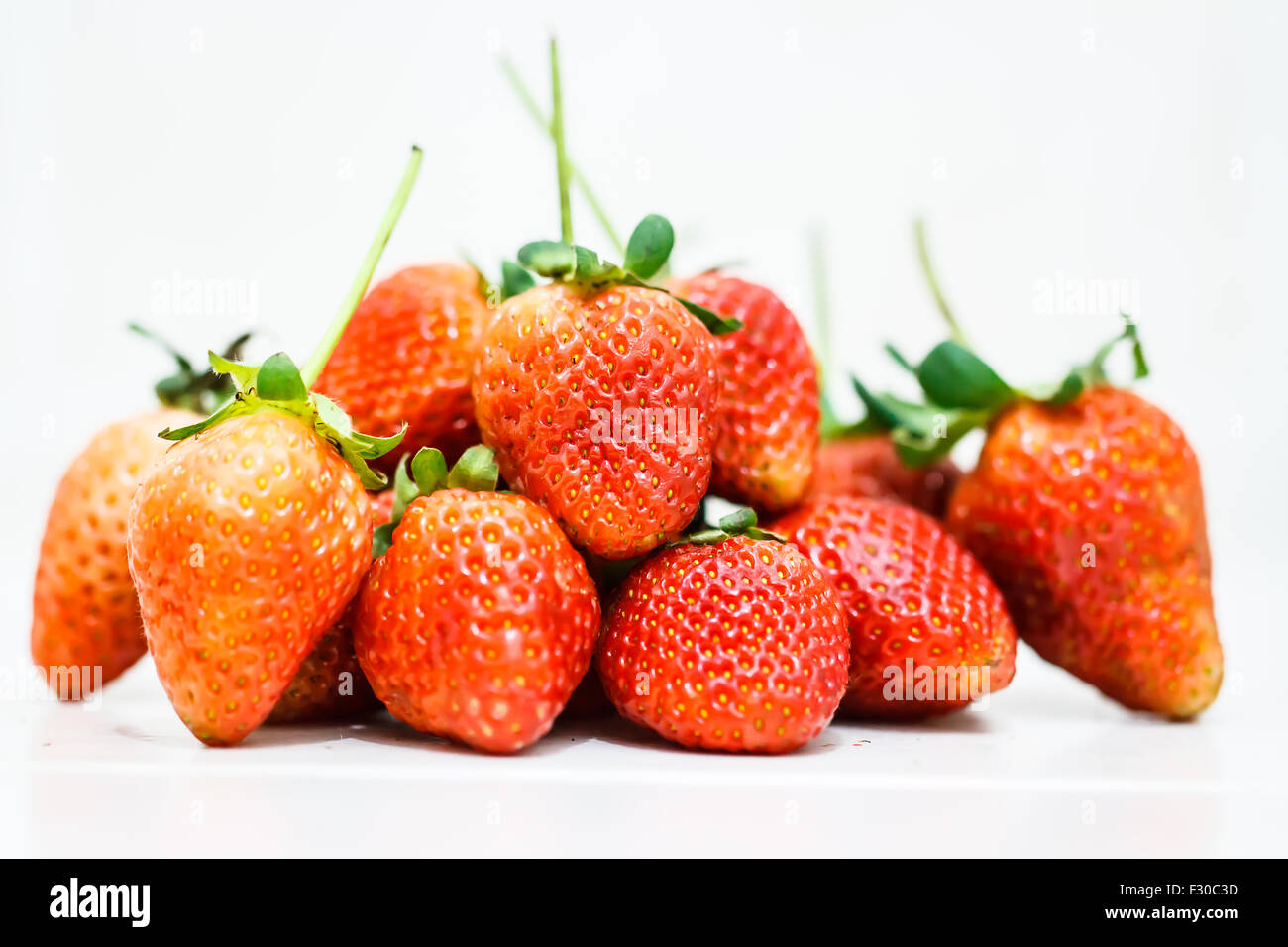 Strawberry berries on a white background Stock Photo - Alamy