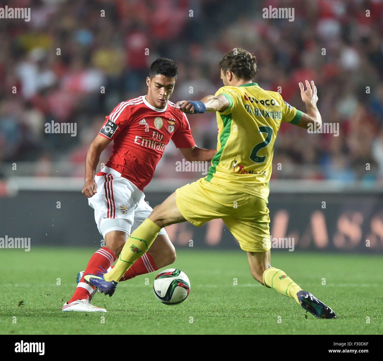 Lisbon, Portugal. 26th Sep, 2015. Pacos Ferreira's Marco Baixinho (R) vies the ball with Benfica's player during the 6th round of Portuguese league soccer match between Benfia and Pacos Ferreira at the Luz stadium in Lisbon, Portugal, Sept. 26, 2015. Benfica beat Pacos Ferreira 3-0. © Zhang Liyun/Xinhua/Alamy Live News Stock Photo