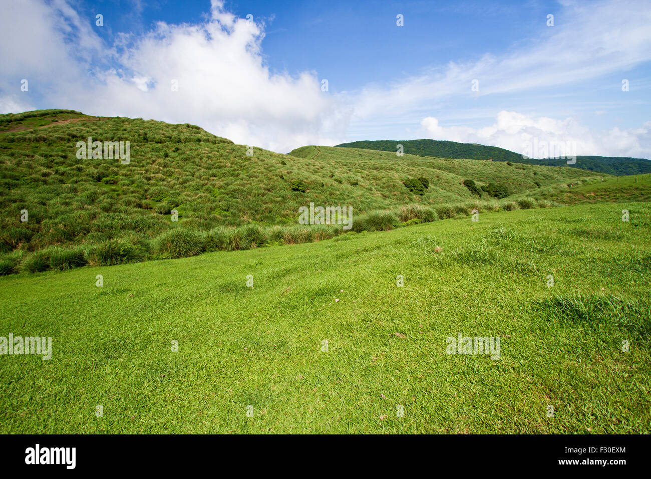 green mountain with blue cloudy sky located in summer Taipei Stock Photo