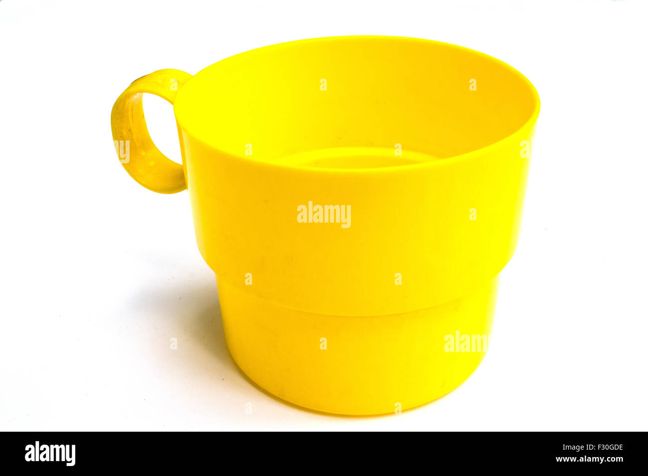 Yellow water cup in white background Stock Photo - Alamy