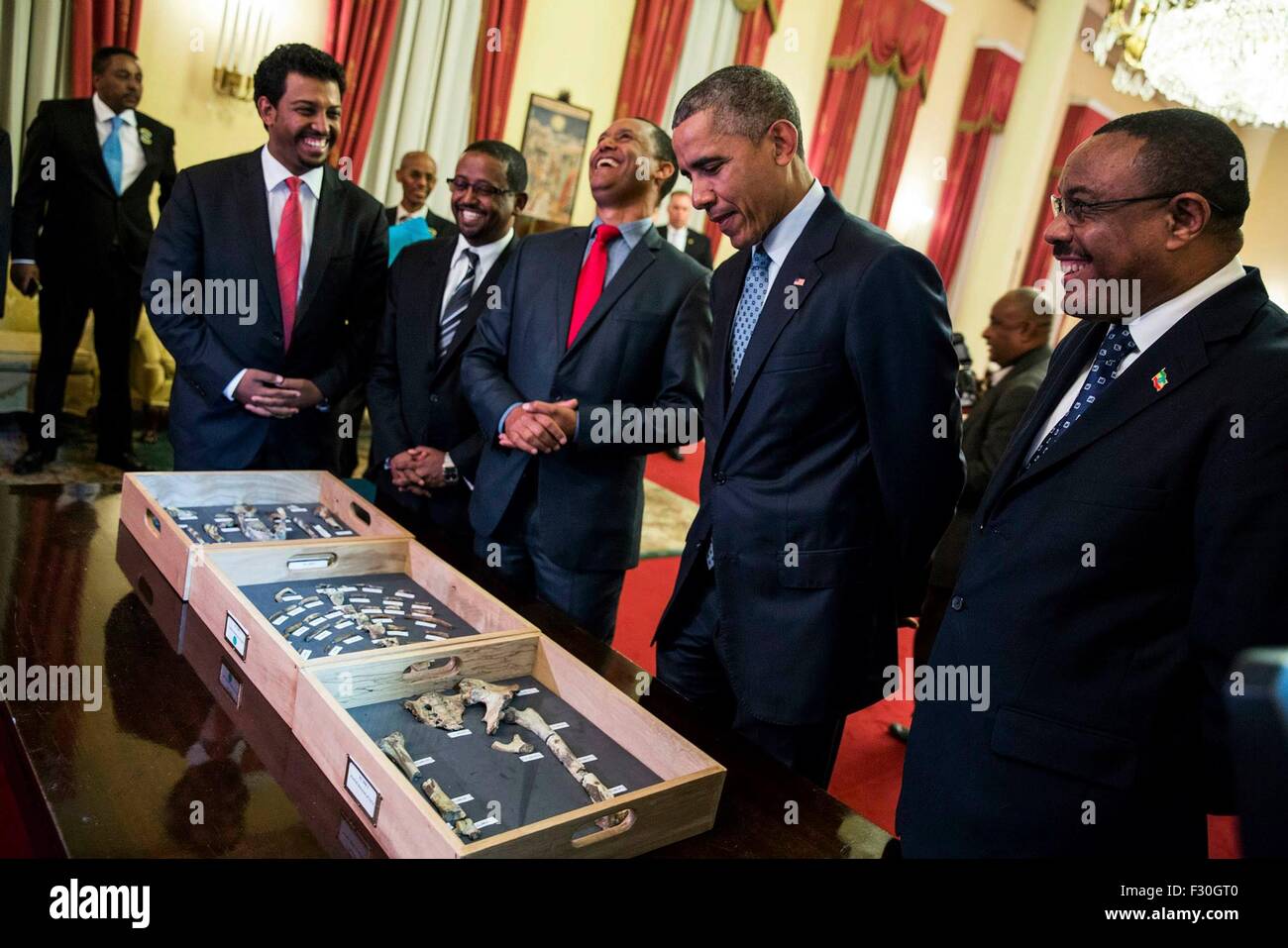 U.S. President Barack Obama and Ethiopia Prime Minister Hailemariam Desalegn view bone fragments belonging to "Lucy," the 3.2 million-year-old fossilized human ancestor as paleoanthropologist Zeresenay Alemseged explains the display at the National Palace July 27, 2015 in Addis Ababa, Ethiopia. Stock Photo