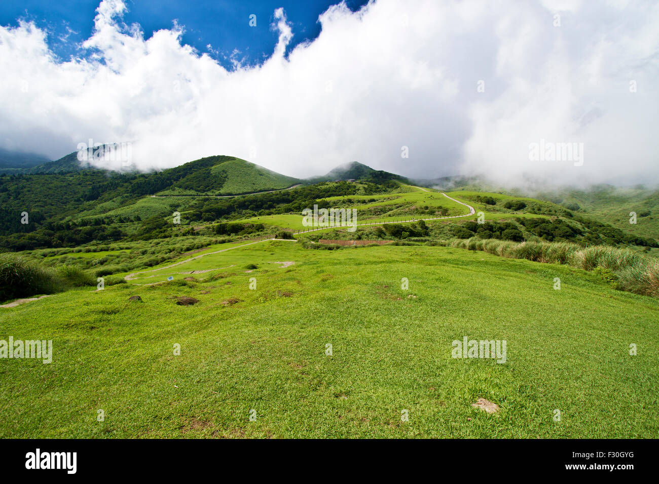 green mountain with blue cloudy sky located in summer Taipei Stock Photo